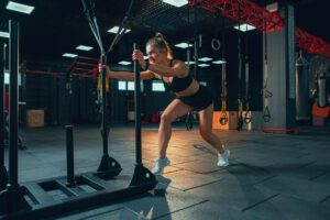 sled push hyrox : femme qui effectue le sled push